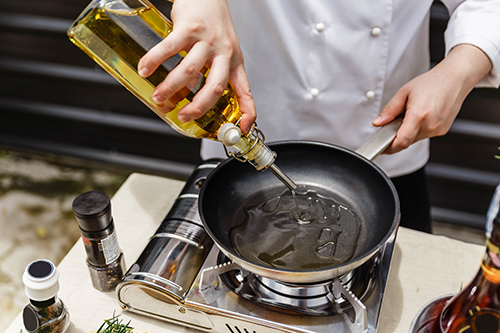 Chef using cooking oil