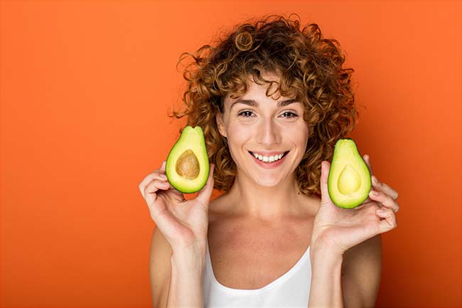 Woman holding avocados
